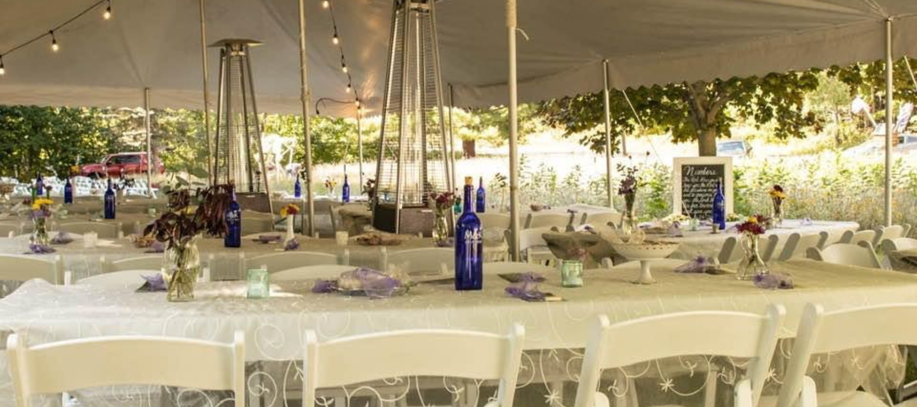 Wedding tables set up under a white tent